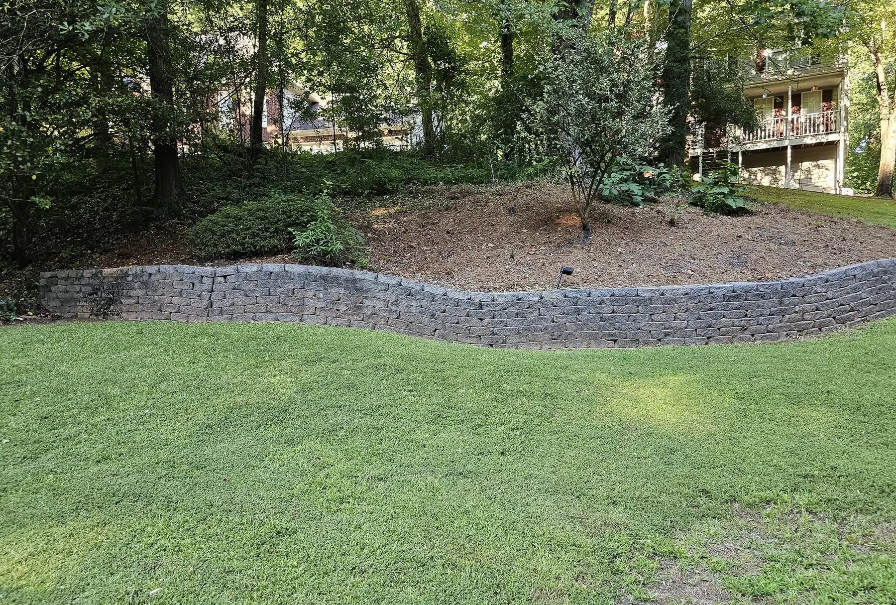 Retaining wall and lawn on a sloped back yard