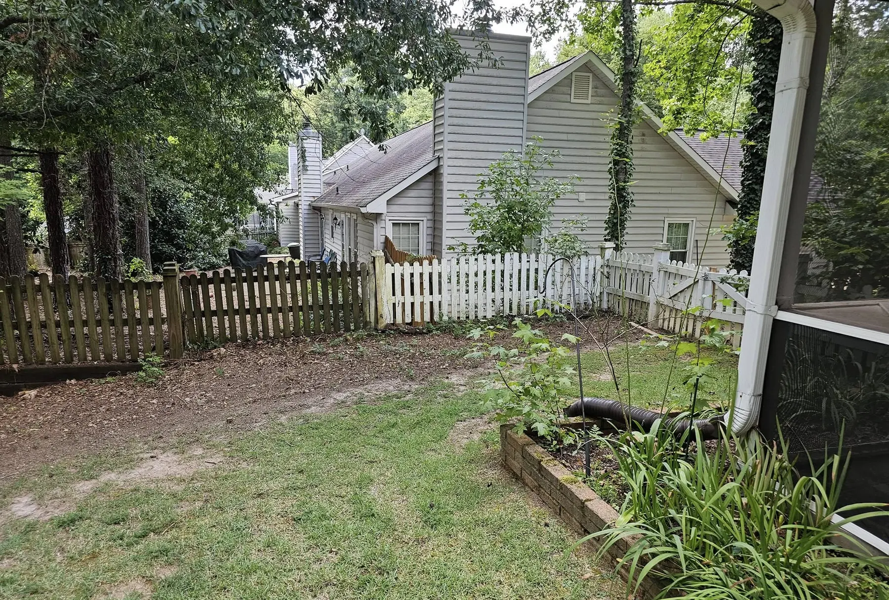 Back yard planting bed and fence line cleaned up