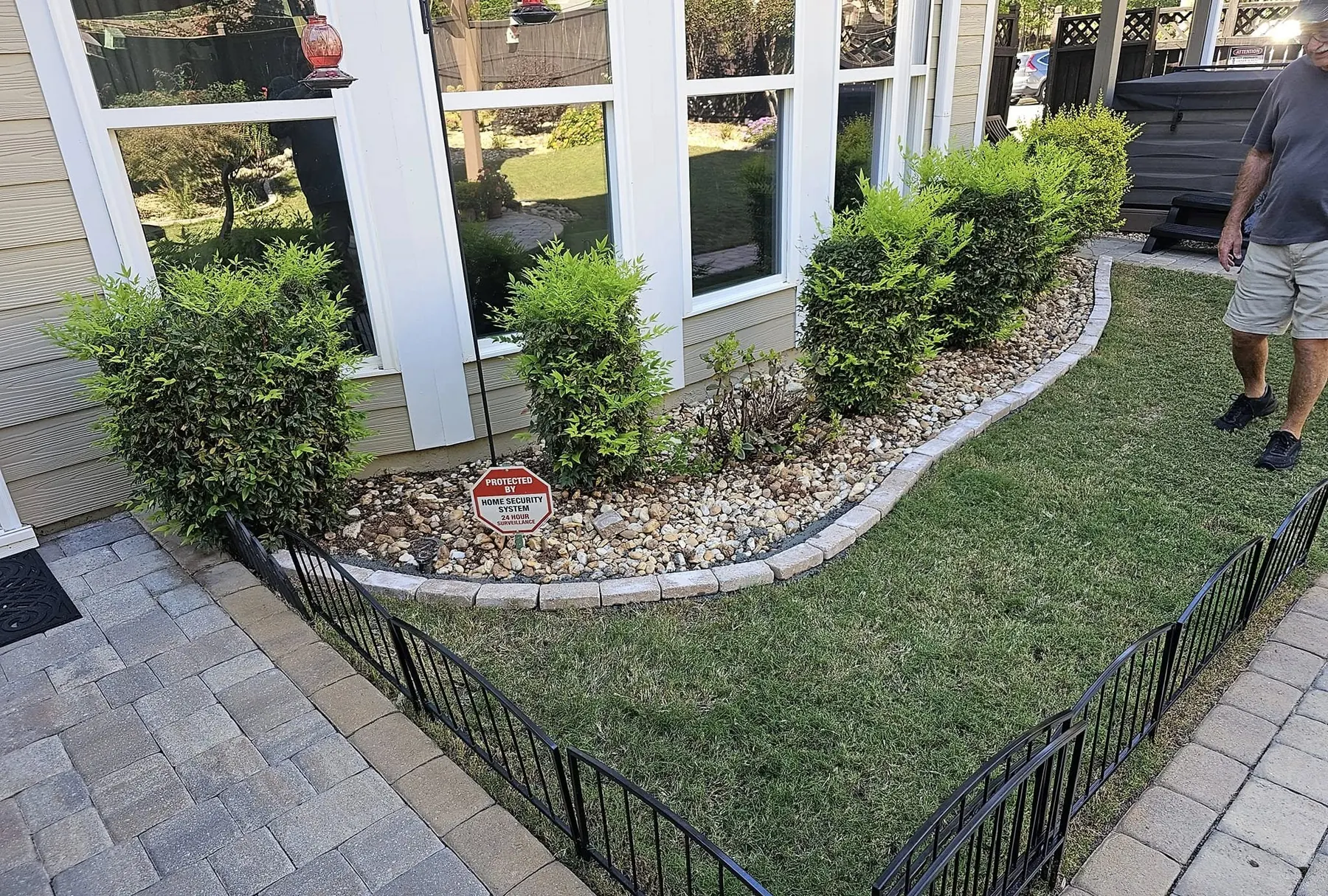 Stone-edged planting bed with fresh gravel and shrubs