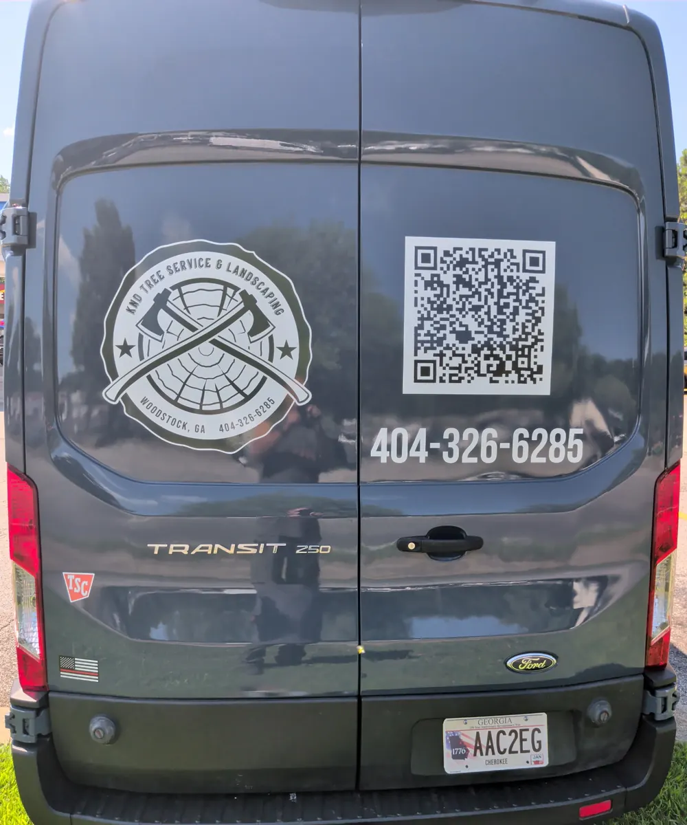 Back of the KND van with the company logo and phone number